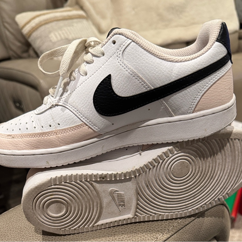 Nike Dunk Low in pink black and white. See all photos